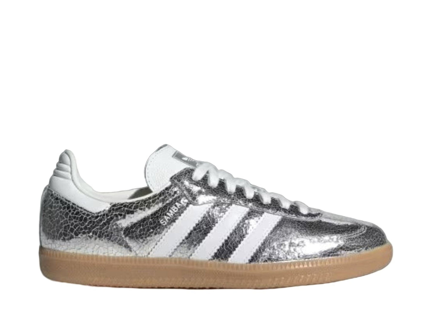 Silver Adidas sneaker with white stripes on a light gray background